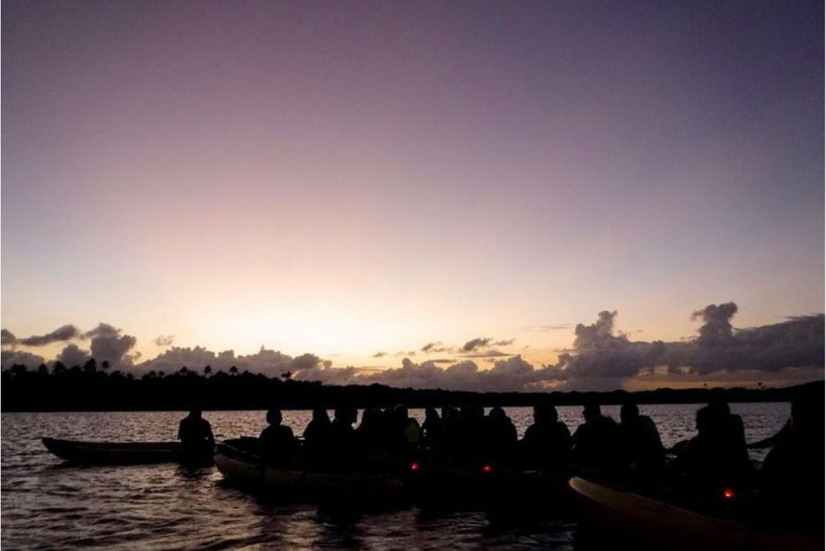 a group of people sitting in a kayak over Laguna Grande